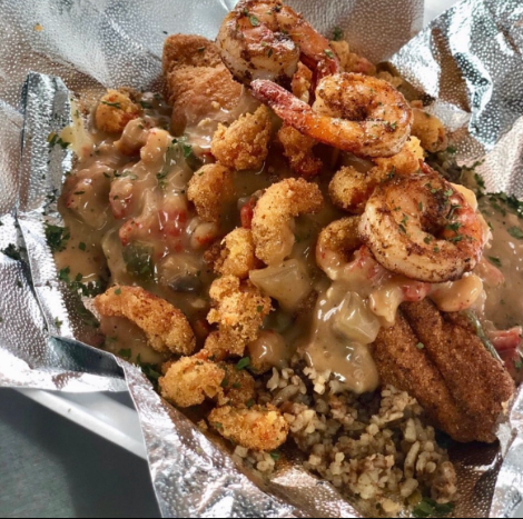 Bayou Fork Kitchen seafood platter with shrimp, fish, dirty rice, and sauce
